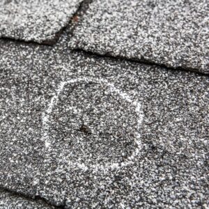 hail damage circled with chalk on roof